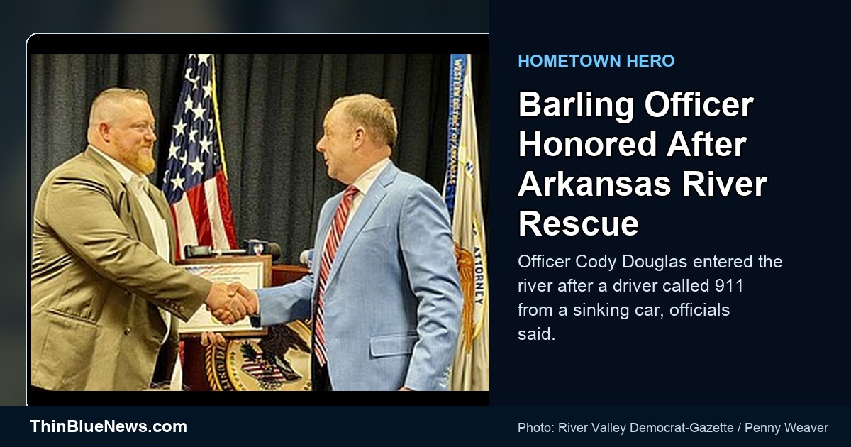 Barling Police Officer Cody Douglas accepts a Hometown Hero Award from U.S. Attorney Kevin Holmes after an Arkansas River rescue, with ThinBlueNews headline overlay