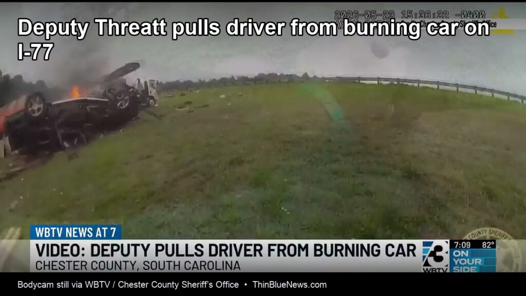 Bodycam still of overturned burning car on I-77 during Deputy Threatt rescue, via WBTV and Chester County Sheriff’s Office