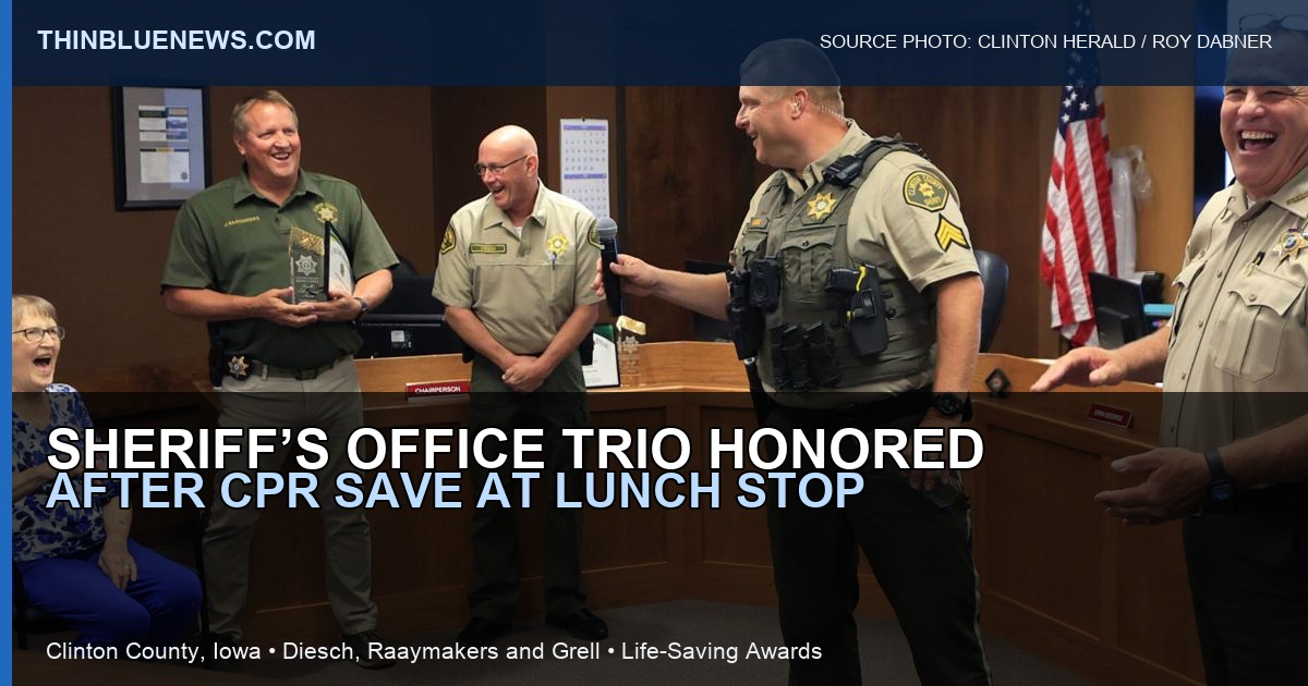 Clinton Herald photo by Roy Dabner showing Sgt. Brian Grell speaking as Jean Hupfer and Clinton County Sheriff’s Office personnel are recognized for a CPR save; ThinBlueNews added headline and source labeling.