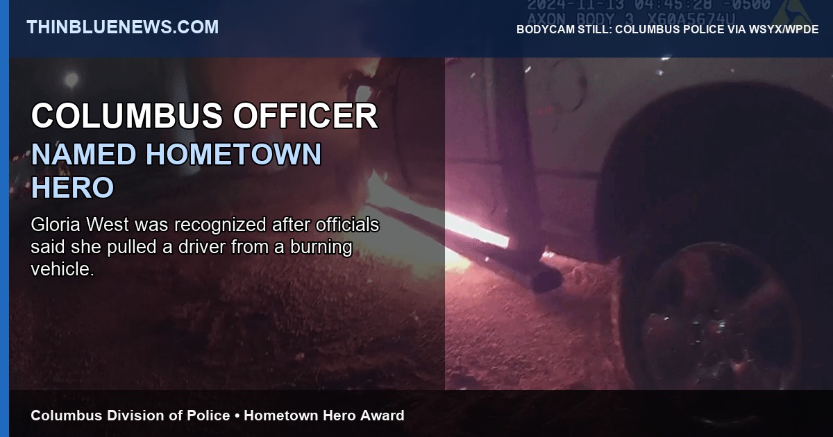 Columbus police body-worn camera still via WSYX/WPDE showing the burning-vehicle rescue scene connected to Officer Gloria West’s Hometown Hero recognition, with ThinBlueNews headline overlay.