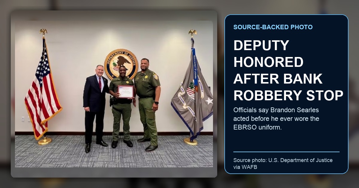 U.S. Department of Justice photo published by WAFB showing East Baton Rouge Sheriff’s Office Deputy Brandon Searles being recognized as a Freedom 250 Hometown Hero; ThinBlueNews added headline and source labeling.