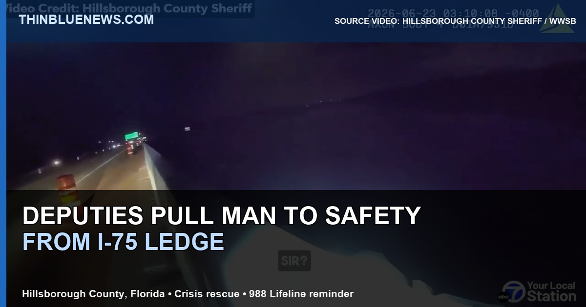 Hillsborough County Sheriff’s Office body-camera source still, as published by WWSB, showing a wide nighttime view of deputies responding on an I-75 overpass before a ledge rescue; ThinBlueNews added headline and source labeling.