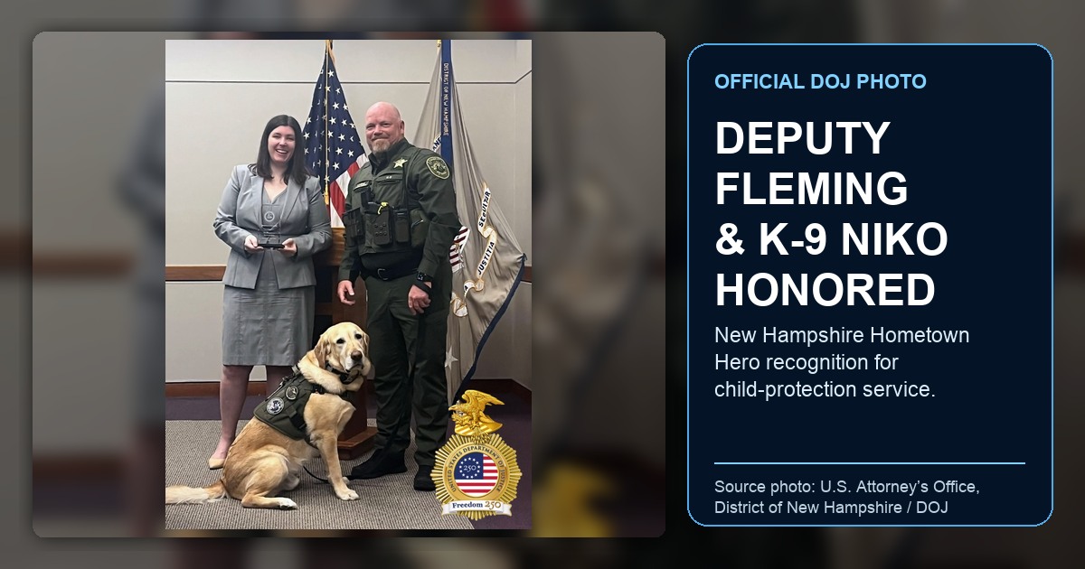Official DOJ photo showing U.S. Attorney Erin Creegan presenting New Hampshire Hometown Hero recognition to Hillsborough County Deputy Matthew J. Fleming with K-9 Niko; ThinBlueNews added headline and source labeling.