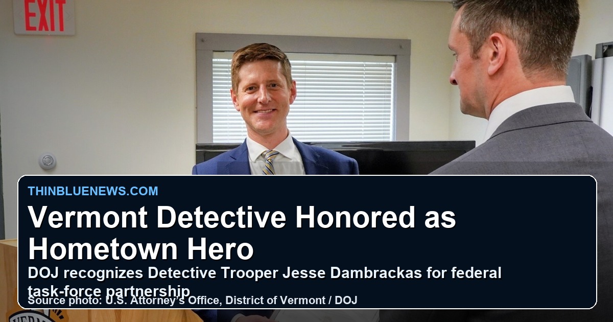 Detective Trooper Jesse Dambrackas receives a Hometown Hero Award at the Vermont State Police Rutland barracks in an official DOJ source photo with a ThinBlueNews headline overlay.