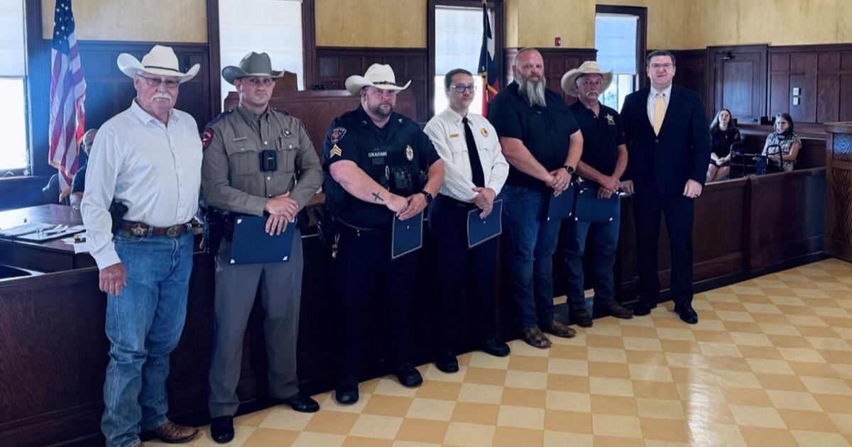 Five Cass County first responders standing with local officials after receiving lifesaving commendations for a June 23 swift-water rescue