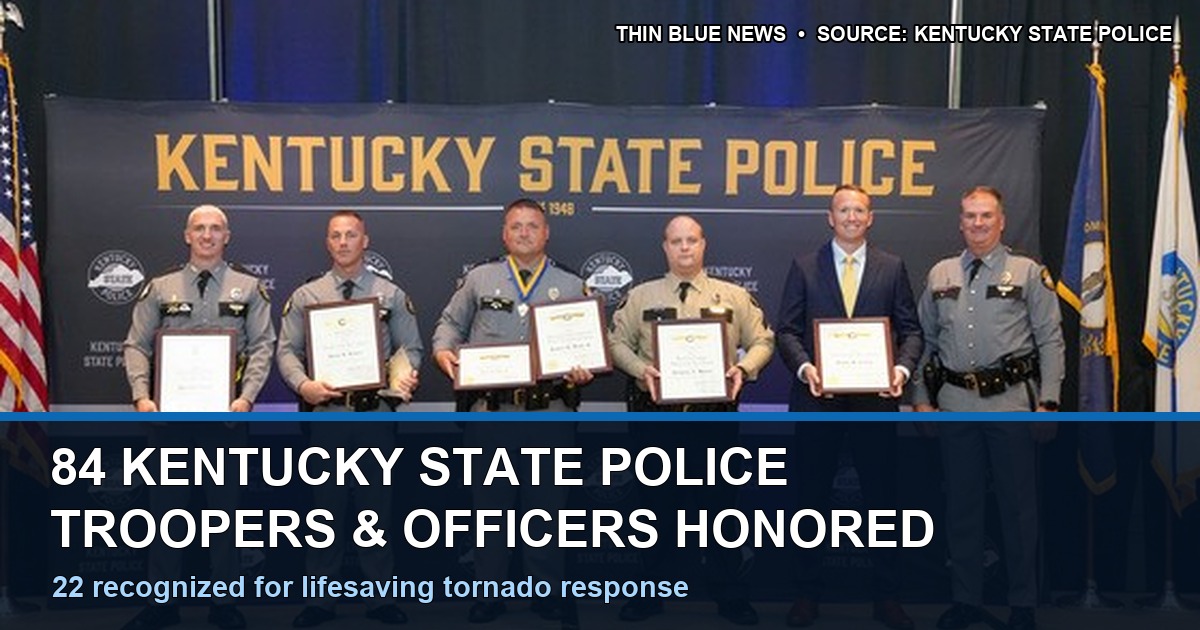 Kentucky State Police official awards ceremony photo showing six men in front of a Kentucky State Police backdrop, five holding certificates; ThinBlueNews added a factual headline and source label