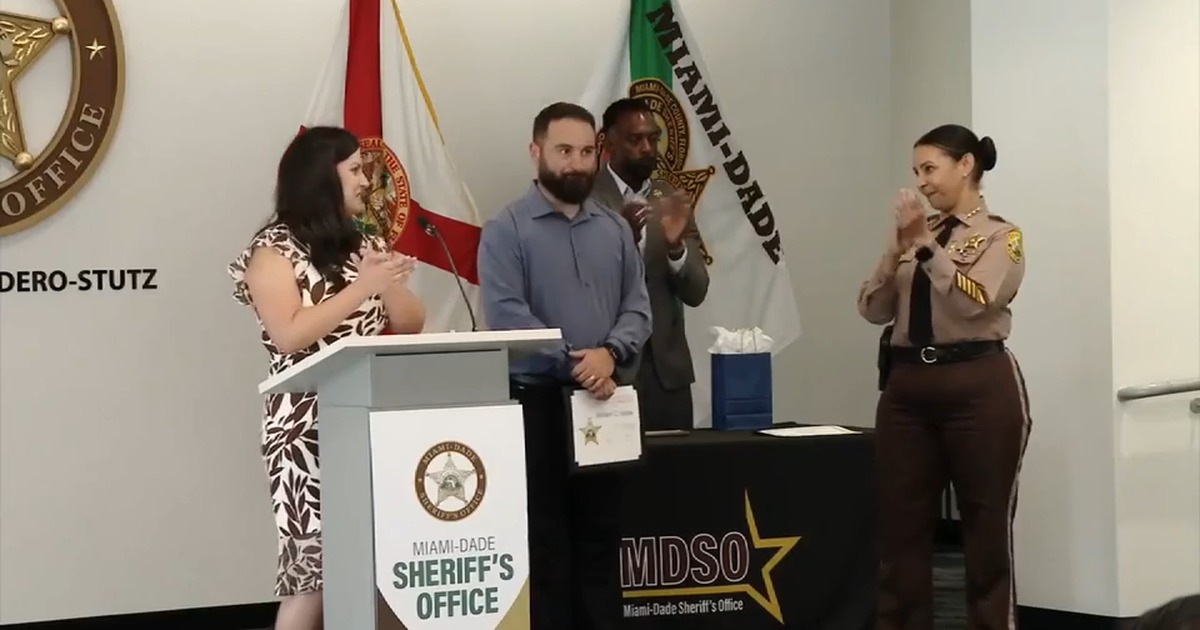 School coach William Varas holding his certificate during a Miami-Dade Sheriff's Office recognition ceremony
