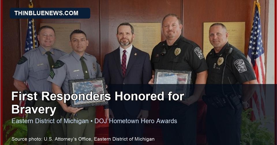Official U.S. Attorney’s Office photo from the Eastern District of Michigan Hometown Hero ceremony showing first responders honored for bravery; ThinBlueNews added headline and source labeling.