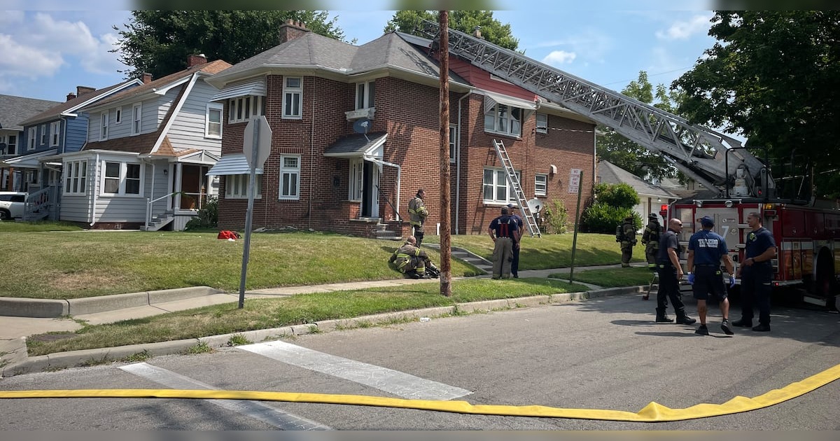 Real WTVG source image showing Toledo firefighters, ladders and a fire truck outside the home where crews rescued a mother and her 5-year-old child