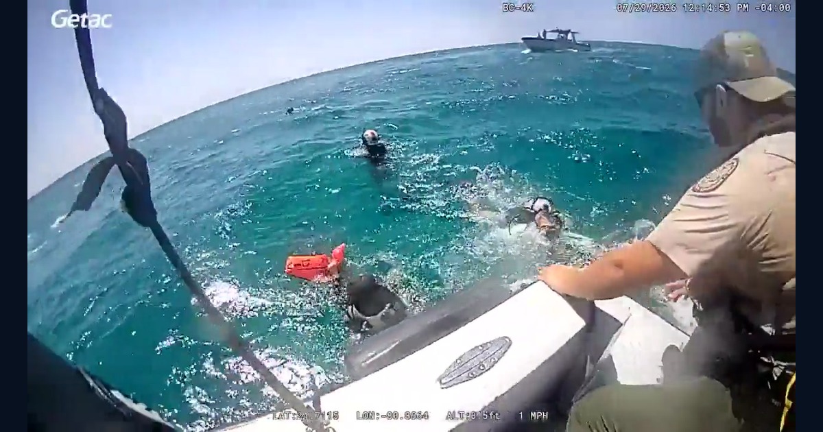 Florida Fish and Wildlife Conservation Commission body-camera frame showing marine officers bringing three separated divers aboard a patrol boat in the Florida Keys.