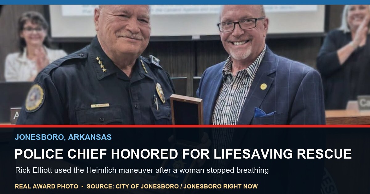 Jonesboro Police Chief Rick Elliott and Mayor Harold Copenhaver hold a Life Saver Award during an August 2026 City Council meeting in Jonesboro, Arkansas.