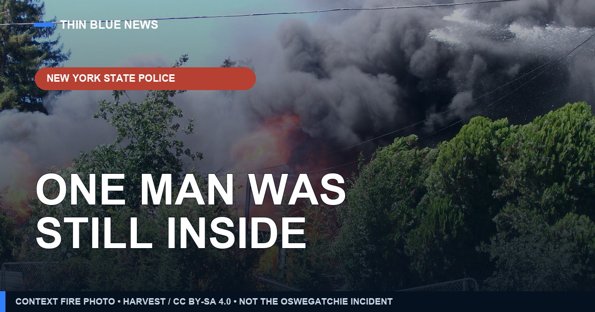 Contextual house-fire photo with the headline ‘One man was still inside’; not an image or body-camera frame from the Oswegatchie rescue.