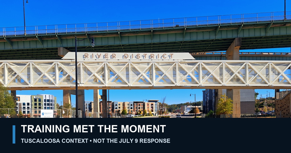 Context photograph of the River District entrance in downtown Tuscaloosa, labeled Training Met the Moment and clearly marked as not depicting the July 9 infant emergency.