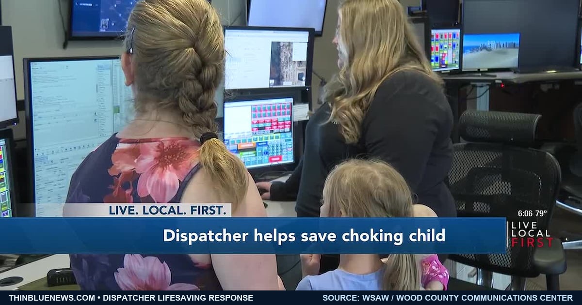 Genuine WSAW news frame from the Wood County Communications Center showing dispatcher Jessica Arnold, mother Jordan Wogerman and 7-year-old Grace during a post-emergency visit, photographed mostly from behind.
