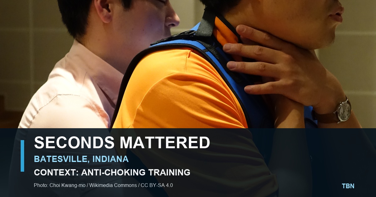 Licensed contextual photograph of adults practicing an anti-choking maneuver in a safety class, labeled as training context and not the Batesville incident.