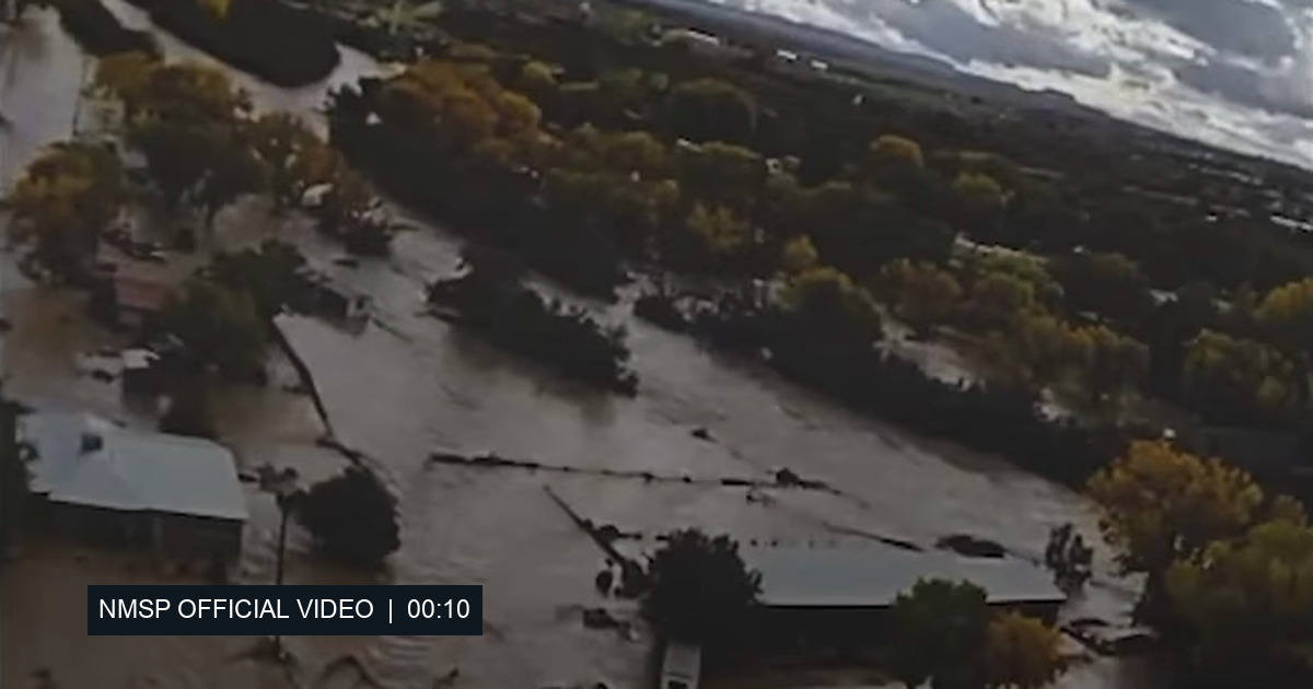 Aerial flood-water view from the New Mexico State Police official video at 00:10; exact filming location and date are not identified.